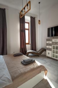 a bedroom with a large bed and a dresser at Vintage Apartament Turda in Turda