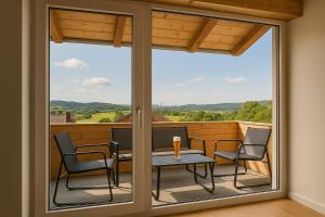 a screened in porch with a table and chairs at SMS-Homes I Auszeit am See #1 in Waltenhofen