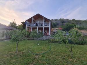 a house with a hose in a yard with trees at Zrmanja Riverside Oasis in Bilišane