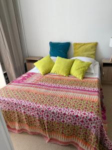 a bed with a colorful blanket and pillows on it at Maison Antibes in Antibes