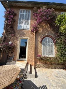 a house with purple flowers on the side of it at Maison Antibes in Antibes