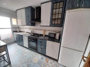 a kitchen with white appliances and a white refrigerator at piso tres habitaciones in Valencia