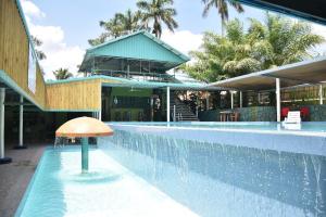 a swimming pool with a mushroom in the middle of a building at Hill Garden Resort Hotel in San Ignacio