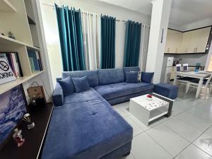 a living room with a blue couch and a table at Vila Reni Risi in Ksamil
