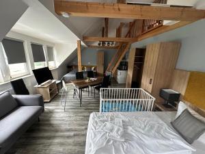 a living room with a bed and a dining room at ElbApartments - Sächsische Schweiz - Ferienwohnungen zum Malerweg - Bastei Urlaub in Pirna