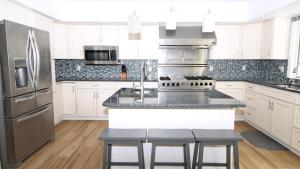 West Cape Mayにある8 Bedrooms With A Pool - 404 Fourth Avenueの白いキャビネットとステンレス製の電化製品を備えたキッチン