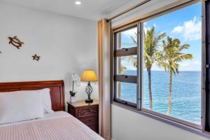 a bedroom with a bed and a window overlooking the ocean at Watch Whales and Sunsets from your Bed - Double Master Sunset Suite in Kihei +67 photos
