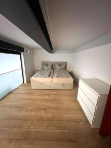 a bedroom with a bed and a wooden floor at To&To Apartments 1 Bedroom in Stuttgart