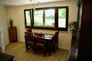 a dining room with a table and chairs and a window at Apartment in Berlin-Köpenick in Berlin +13 photos