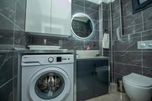 a bathroom with a washing machine and a sink at Villa Özel in Fethiye +24 photos