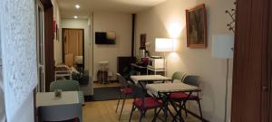 a room with two tables and chairs and a living room at Moimenta Guest House in Mindelo