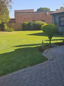 Un camino de ladrillos en un patio con un árbol en el medio. en 43 Home apartment, en Del Judor