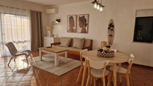 a living room with a couch and a table at Serenity Villa in Porches