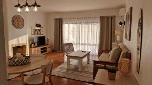 a living room with a couch and a table at Serenity Villa in Porches