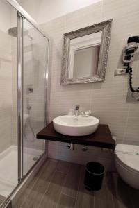 a bathroom with a sink and a shower and a toilet at CdR Guest House in Rome