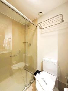 a bathroom with a toilet and a glass shower at UniHome Niterói in Niterói +4 photos