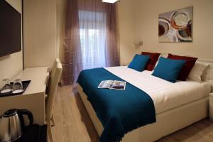 a bedroom with a large bed with blue pillows at CdR Guest House in Rome