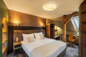 Postel nebo postele na pokoji v ubytování Hotel Bílý jednorožec