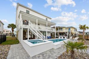 a house with a swimming pool in front of it at Sunset Shack in Myrtle Beach