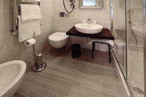 a bathroom with a sink and a toilet and a shower at CdR Guest House in Rome