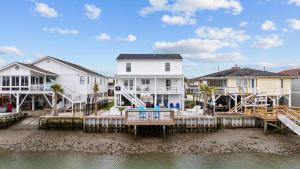 a house with a dock in the water at Sunset Shack in Myrtle Beach