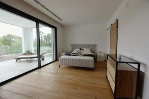 a bedroom with a bed and a large window at Villa contemporaine de luxe in Aix-en-Provence +77 photos
