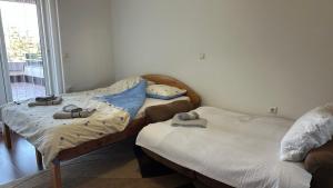 two twin beds in a room with a window at Riverside Apartment in Struga