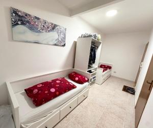 a bedroom with a bed with red pillows on it at Fantastic sea & harbour view Nino Bixio in Castellammare del Golfo