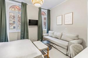 a living room with a bed and a couch at Apartments I 5 Min to Millennium City Mall and Handelskai U6 in Vienna