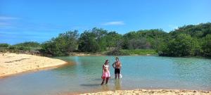 a man and a woman standing in the water at Casa d Amar in Paripueira +14 photos