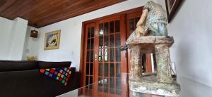 a statue sitting on a glass table in a living room at Casa Ouro Preto in Ouro Preto