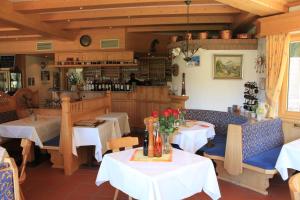 a restaurant with tables and chairs and a bar at Apartment Zugspitz in Farchant
