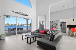a living room with a couch and a table and a kitchen at Villa Stella in Cape Coral