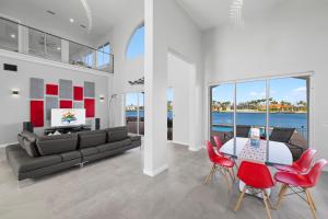 a living room with a couch and a table and chairs at Villa Stella in Cape Coral