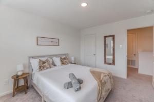 a bedroom with a bed with a teddy bear on it at Pool house with hot tub in Houston +34 photos