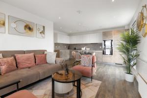 a living room with a couch and a table at Khayat Homes - The Lasgidi - Two Bed Apt in Barking