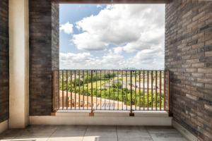 a window in a brick wall looking out at a view at Khayat Homes - The Lasgidi - Two Bed Apt in Barking