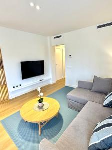 a living room with a couch and a coffee table at CALA FORN y CLIMATIZADA in Les tres Cales