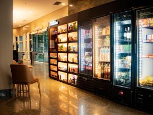 a store with a refrigerator filled with food at BFC Suíte em Barra da Tijuca in Rio de Janeiro