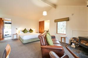 a living room with a bed and a couch at Peppers Cradle Mountain Lodge in Cradle Mountain