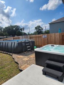 a backyard with a pool and a hot tub at Pool house with hot tub in Houston