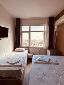 Postel nebo postele na pokoji v ubytování Sera Hotel