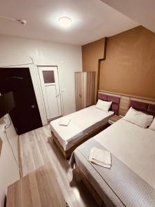 Postel nebo postele na pokoji v ubytování Sera Hotel