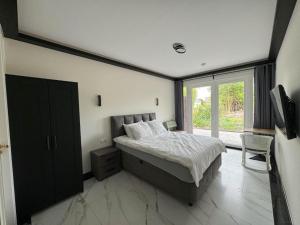 a bedroom with a bed and a large window at B&B Hu Renesse in Renesse
