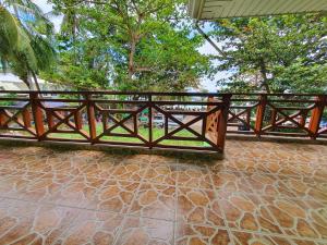 a wooden fence on a stone floor with trees in the background at Resort Manuela Panglao in Panglao