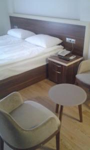 Postel nebo postele na pokoji v ubytování Merkez Otel