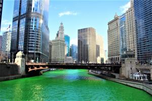 a green river with a bridge in a city at Residence Inn Chicago O'Hare in Rosemont
