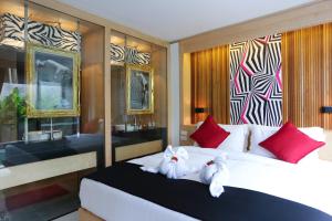 Postel nebo postele na pokoji v ubytování Pavilion Pool Residence Samui - SHA Extra Plus
