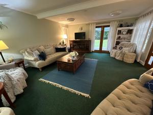 a living room with a couch and a coffee table at Maleny Retreat - Pay 3 Stay 4 nights! First 3 bookings only! in Booroobin