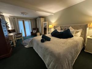 a bedroom with a large bed with black pillows at Maleny Retreat - Pay 3 Stay 4 nights! First 3 bookings only! in Booroobin +52 photos